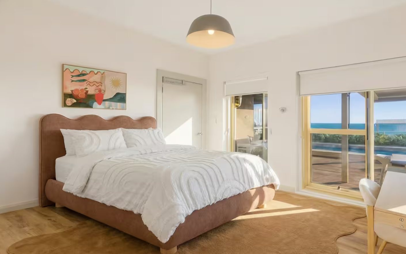 Double bedroom opening to the balcony over the pool